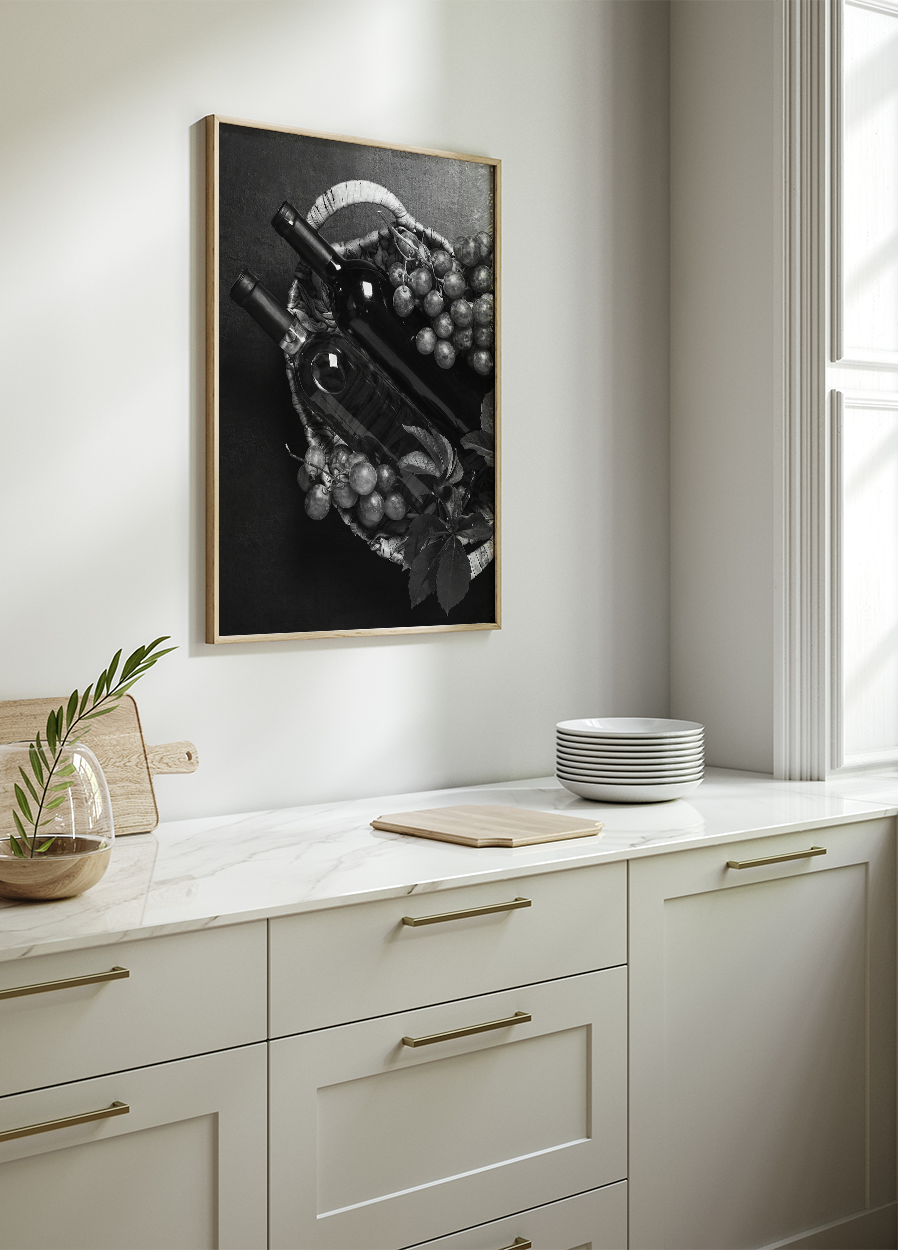 a black and white photo of a kitchen with a bowl of grapes on the counter