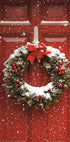 a red door with a wreath and bells on it