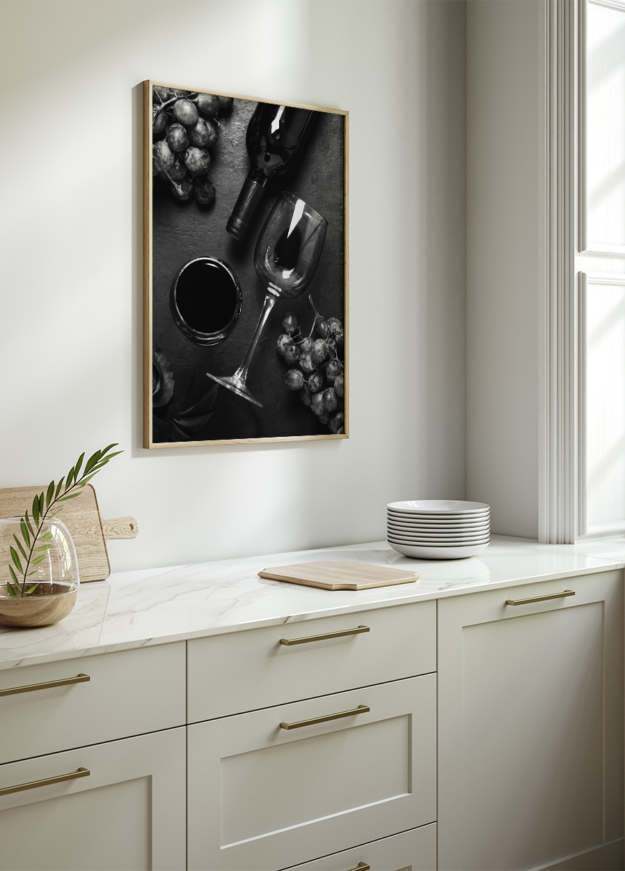 a black and white photo of a kitchen with a wine glass