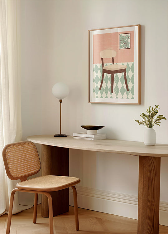 a cozy corner of a room with a wooden desk, a woven chair, a lamp, and a framed artwork depicting a chair on a patterned floor.
