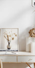a white desk with a vase of flowers on it