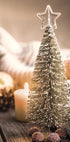 a small christmas tree sitting on top of a wooden table