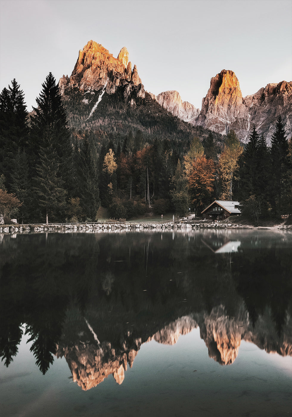 House At The Foot Of A Mountain Near A Lake Poster